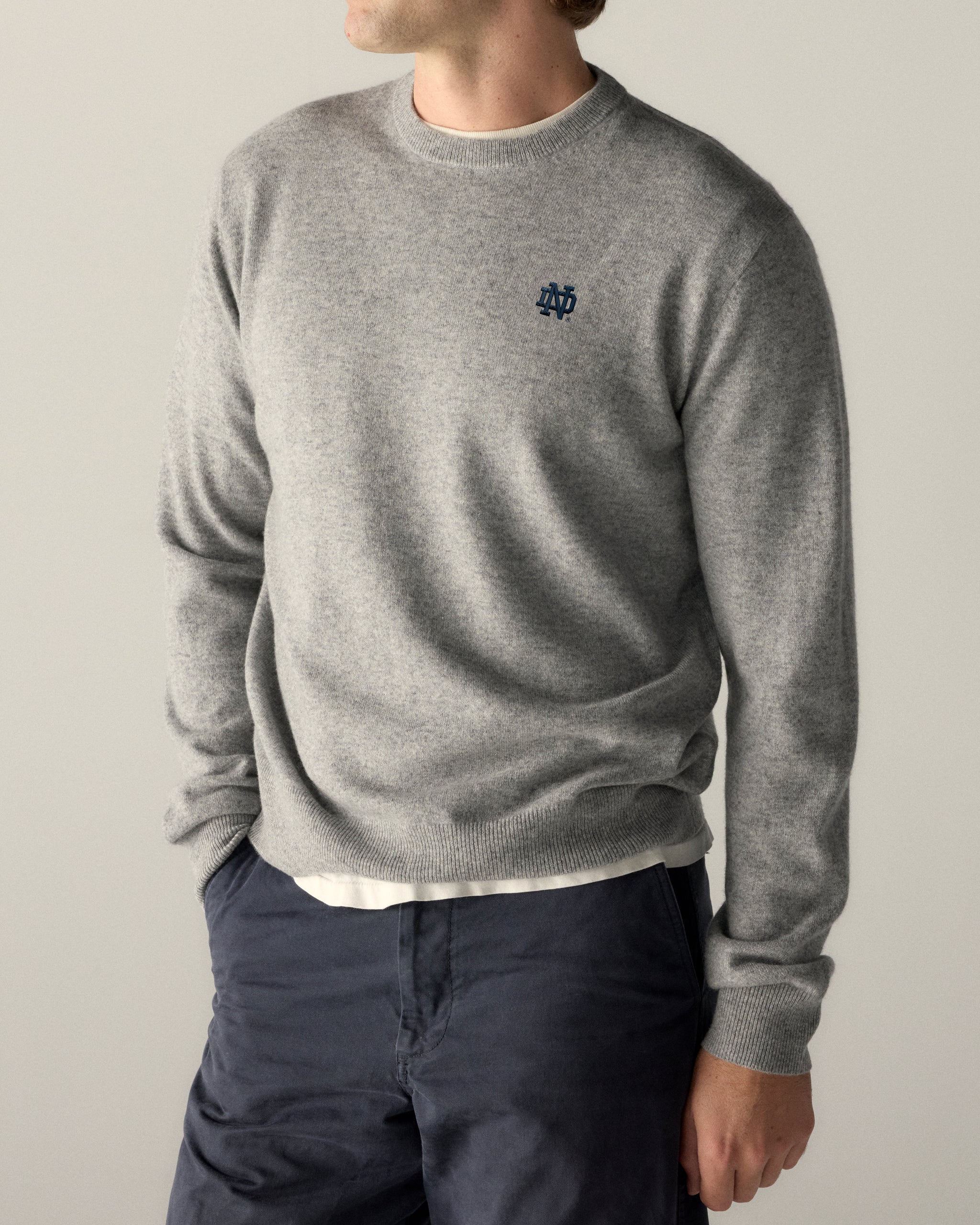 Men's grey merino crewneck sweater with embroidered collegiate logo, casual outfit. Class Trip | Officially Licensed Collegiate Apparel