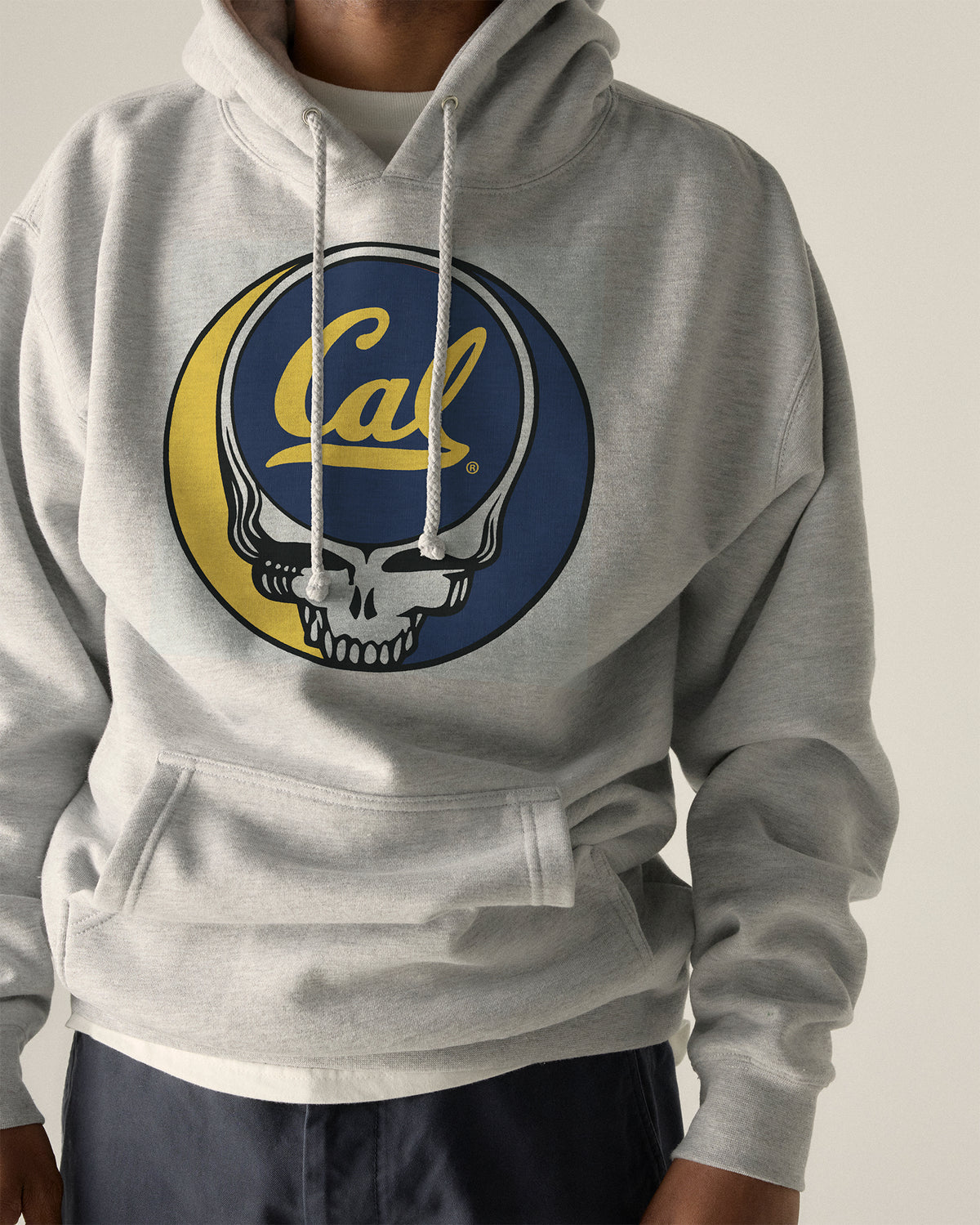 Model wearing the Heather Grey Cal Berkeley x Grateful Dead Steal Your Face Hoodie, front view. Class Trip | Higher Education