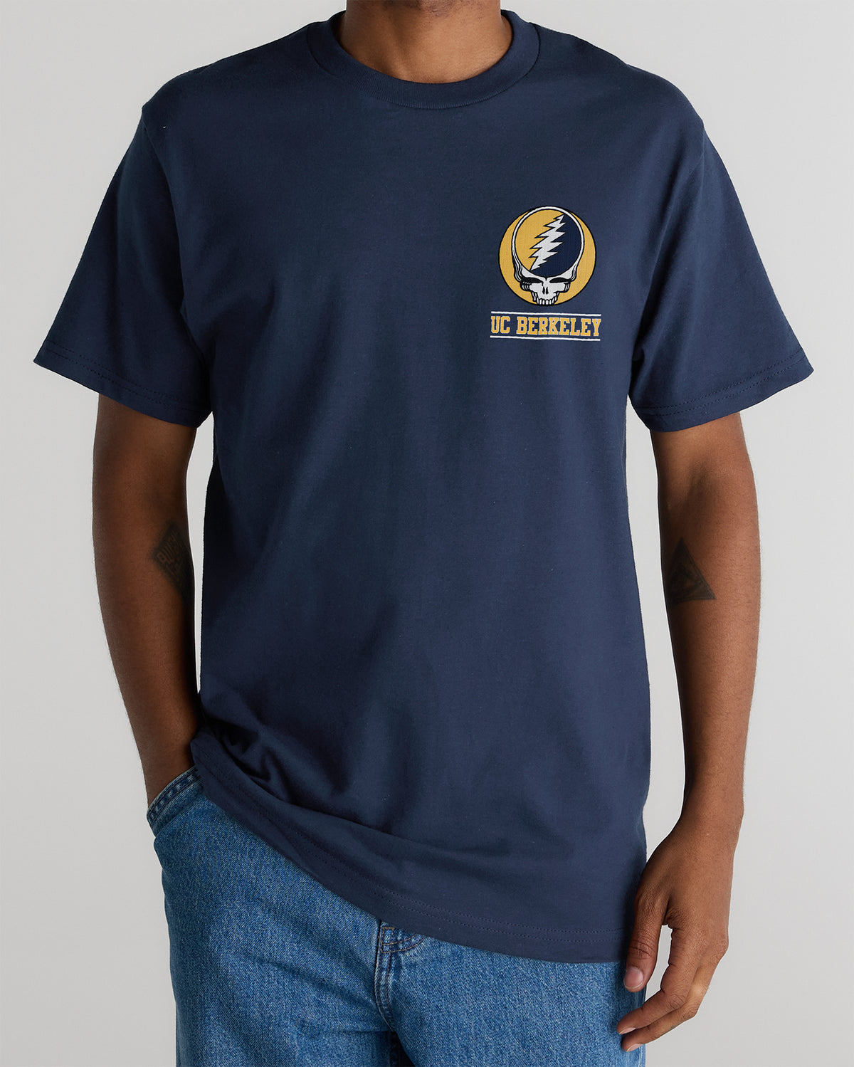 Model wearing the Navy Cal Berkeley x Grateful Dead Berkeley Steal Your Face Tee, front view. Class Trip | Higher Education