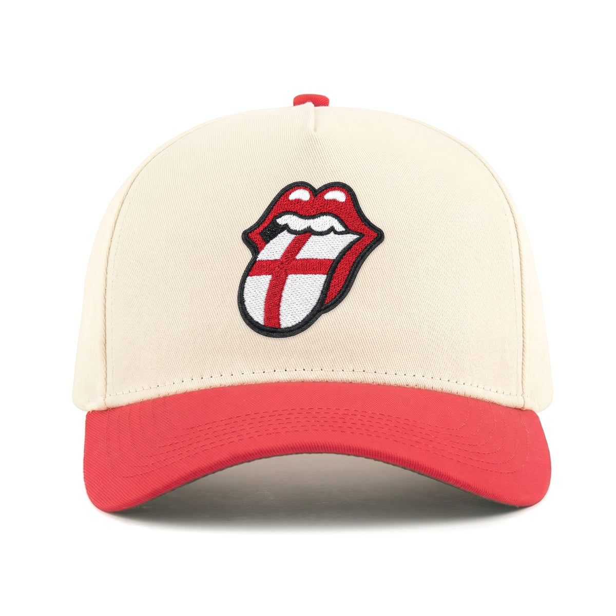 Cream and red baseball cap with embroidered Rolling Stones tongue logo featuring England flag design. Class Trip | Higher Education
