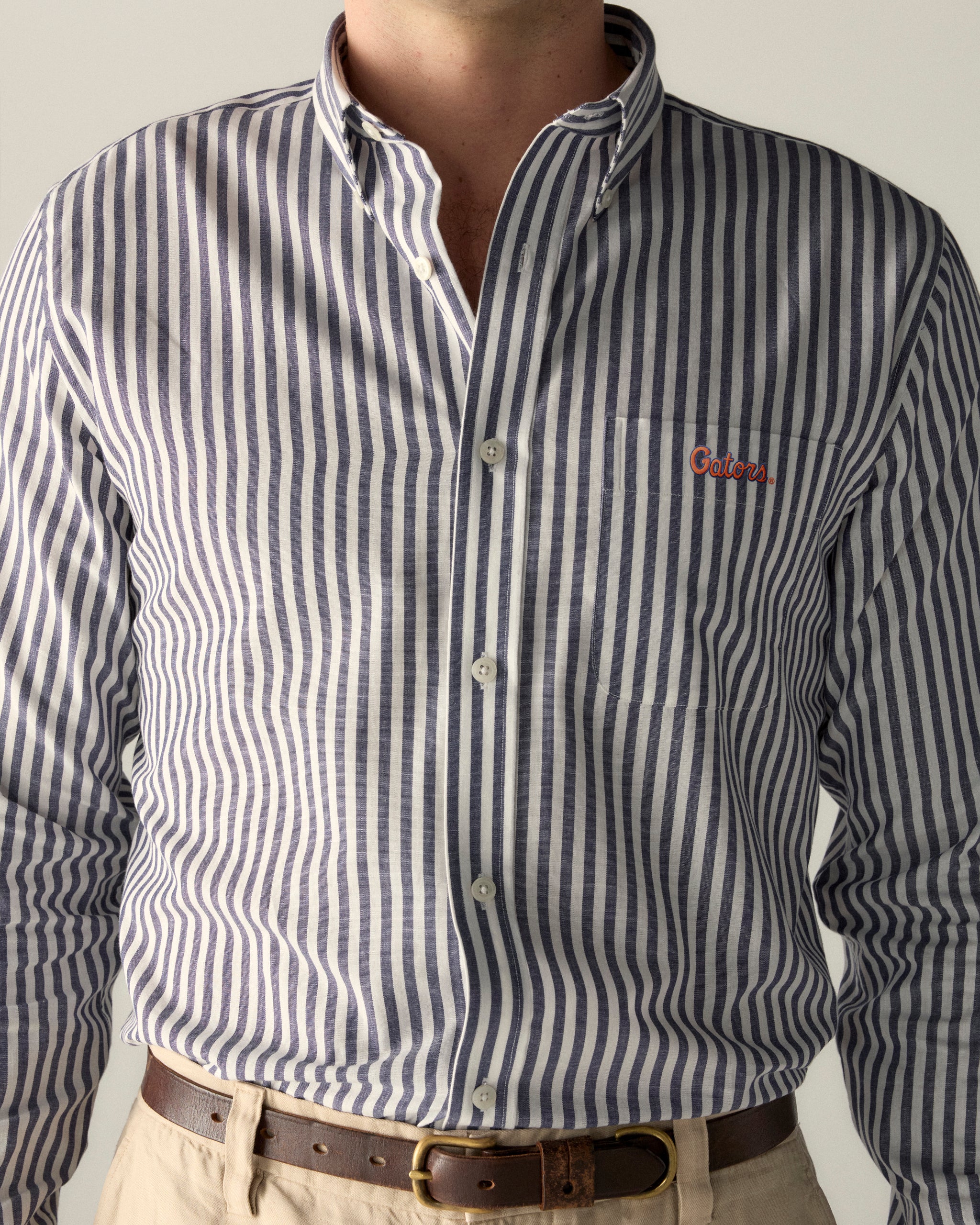 Men’s navy and white striped poplin button-down shirt with Gators embroidery, collegiate style. Class Trip | Officially Licensed Collegiate Apparel