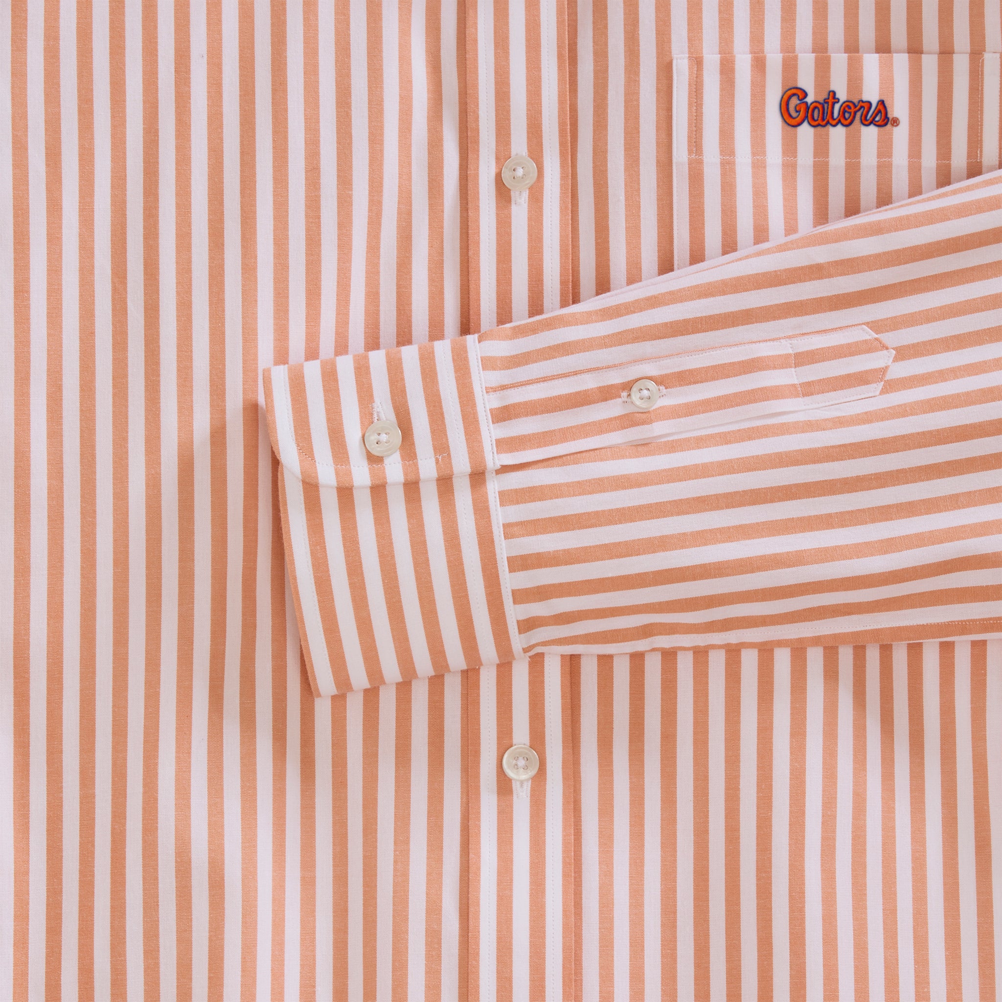 Detail of orange and white striped women's poplin shirt with embroidered "Gators" logo, button cuff. Class Trip | Officially Licensed Collegiate Apparel