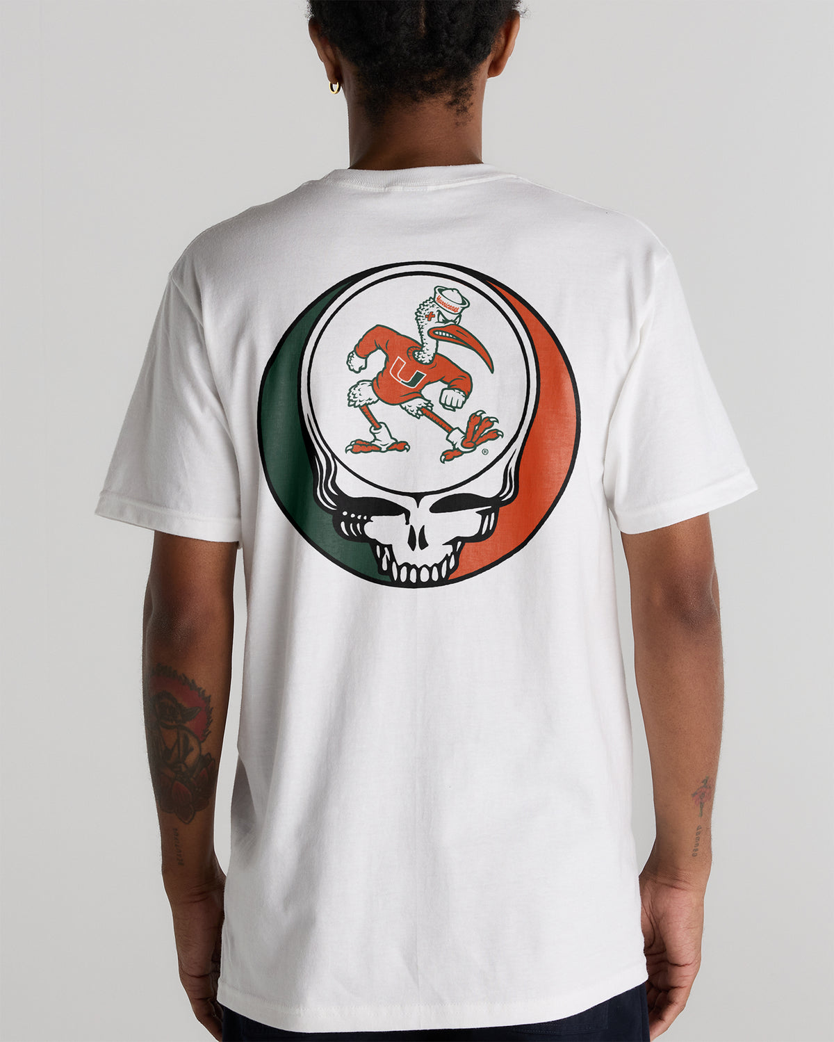 Back view of a white tee featuring a University of Miami x Grateful Dead graphic. Class Trip | Higher Education