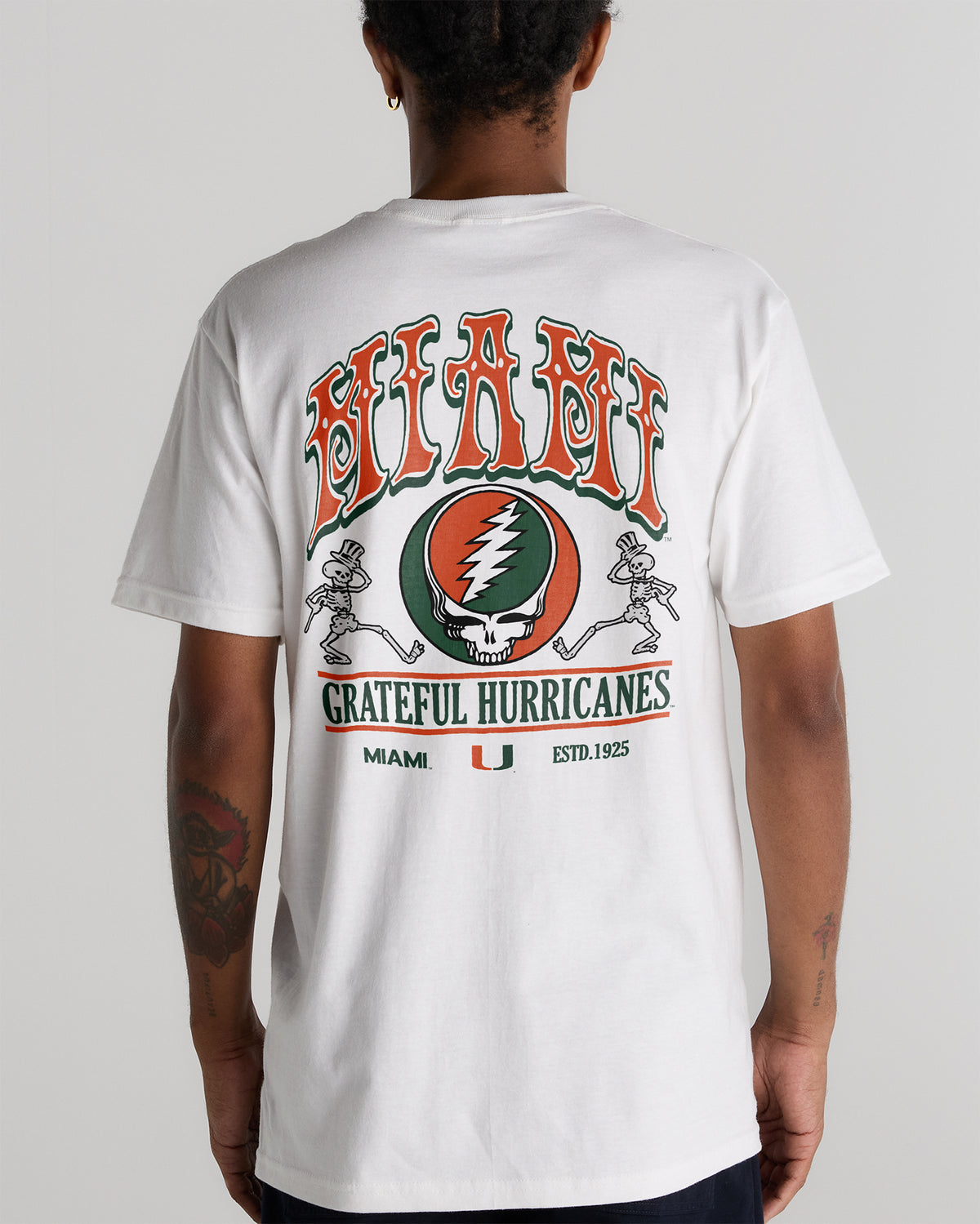Back view of a white Class Trip t-shirt with a University of Miami x Grateful Dead graphic. University of Miami x Grateful Dead Shakedown Tee Class Trip | Higher Education
