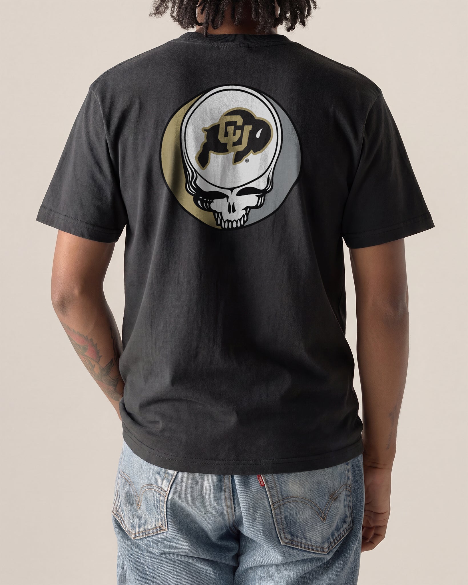 Black t-shirt with skull and CU logo, worn by person in jeans, Class Trip | Higher Education