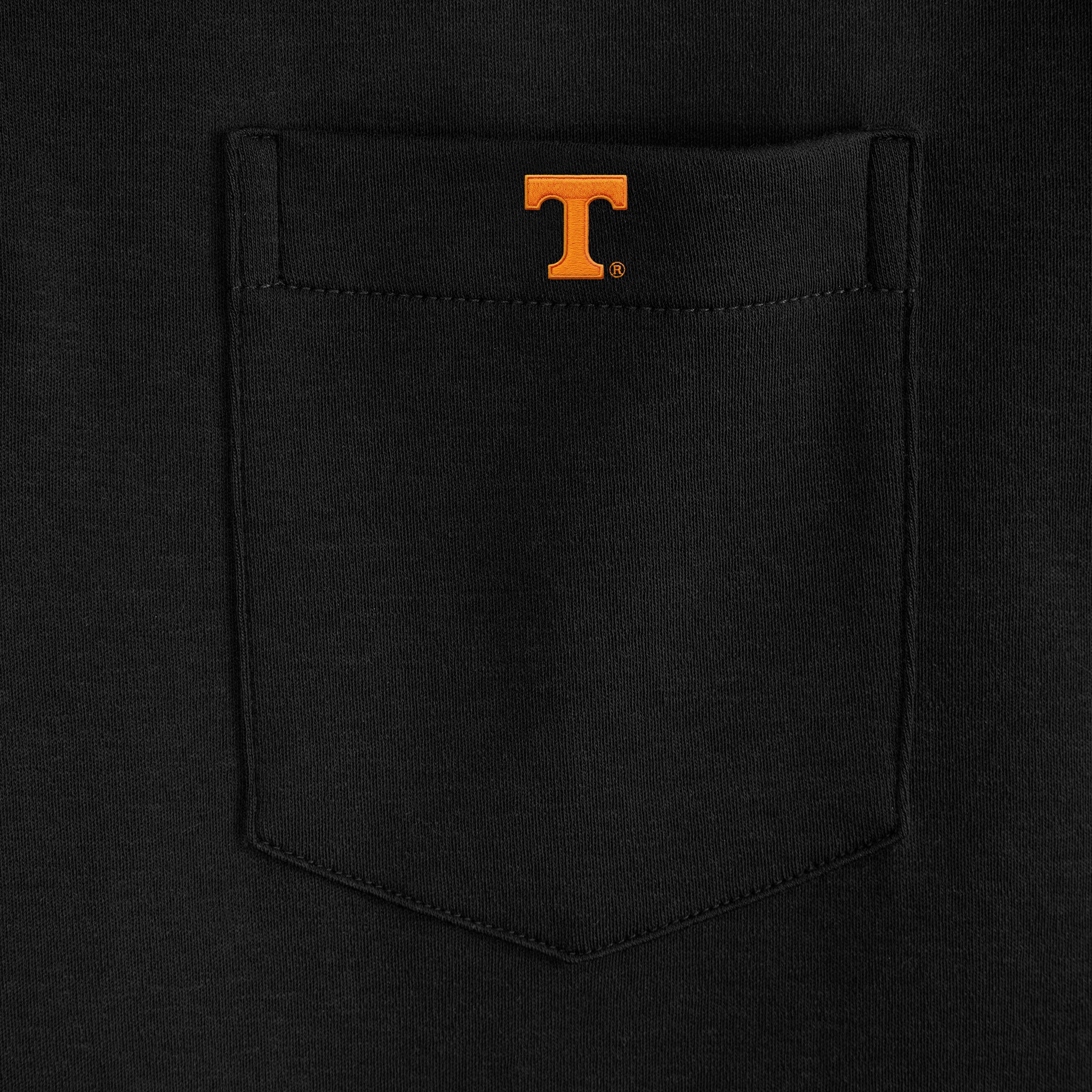 Black polo shirt pocket with orange collegiate T emblem, Class Trip | Officially Licensed Collegiate Apparel