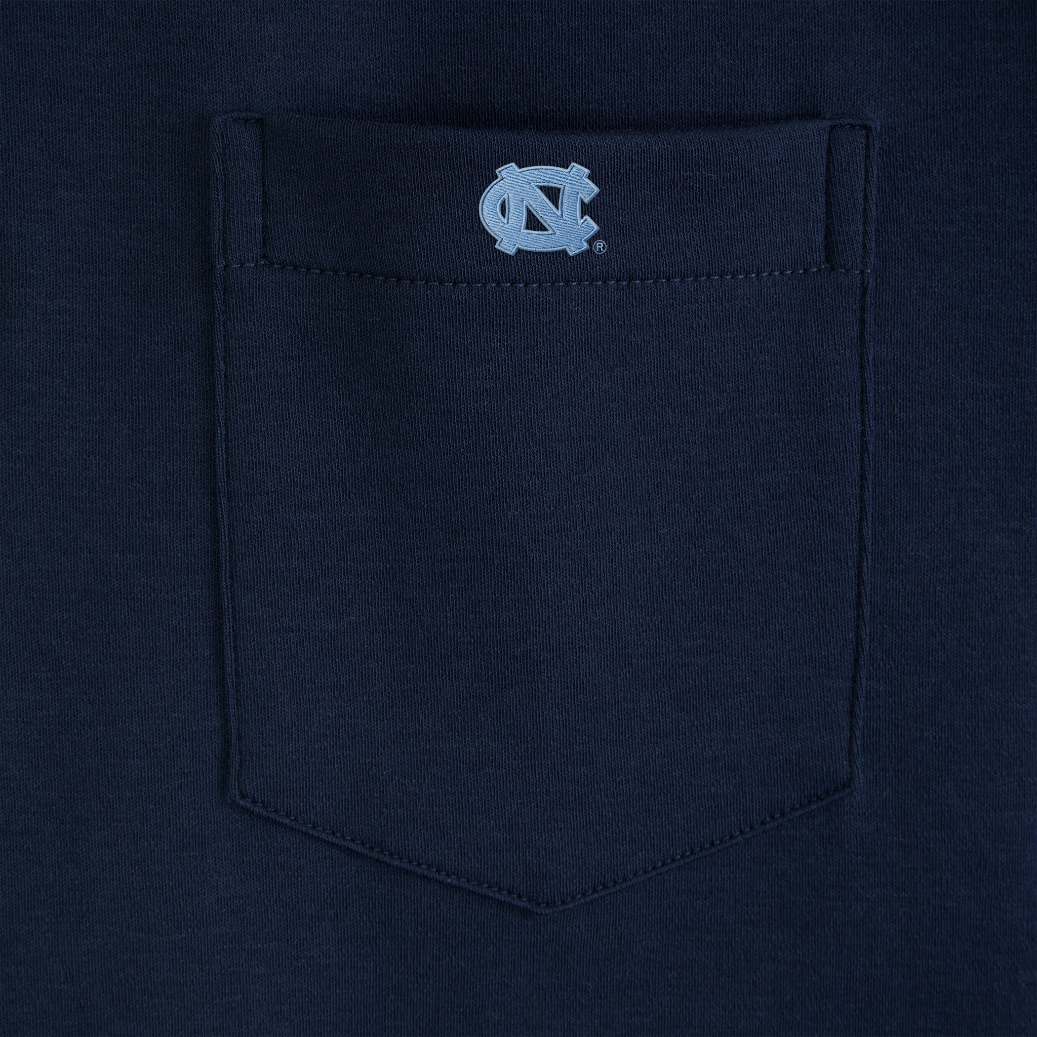 Navy blue tee with embroidered UNC logo on chest pocket. Class Trip | Officially Licensed Collegiate Apparel