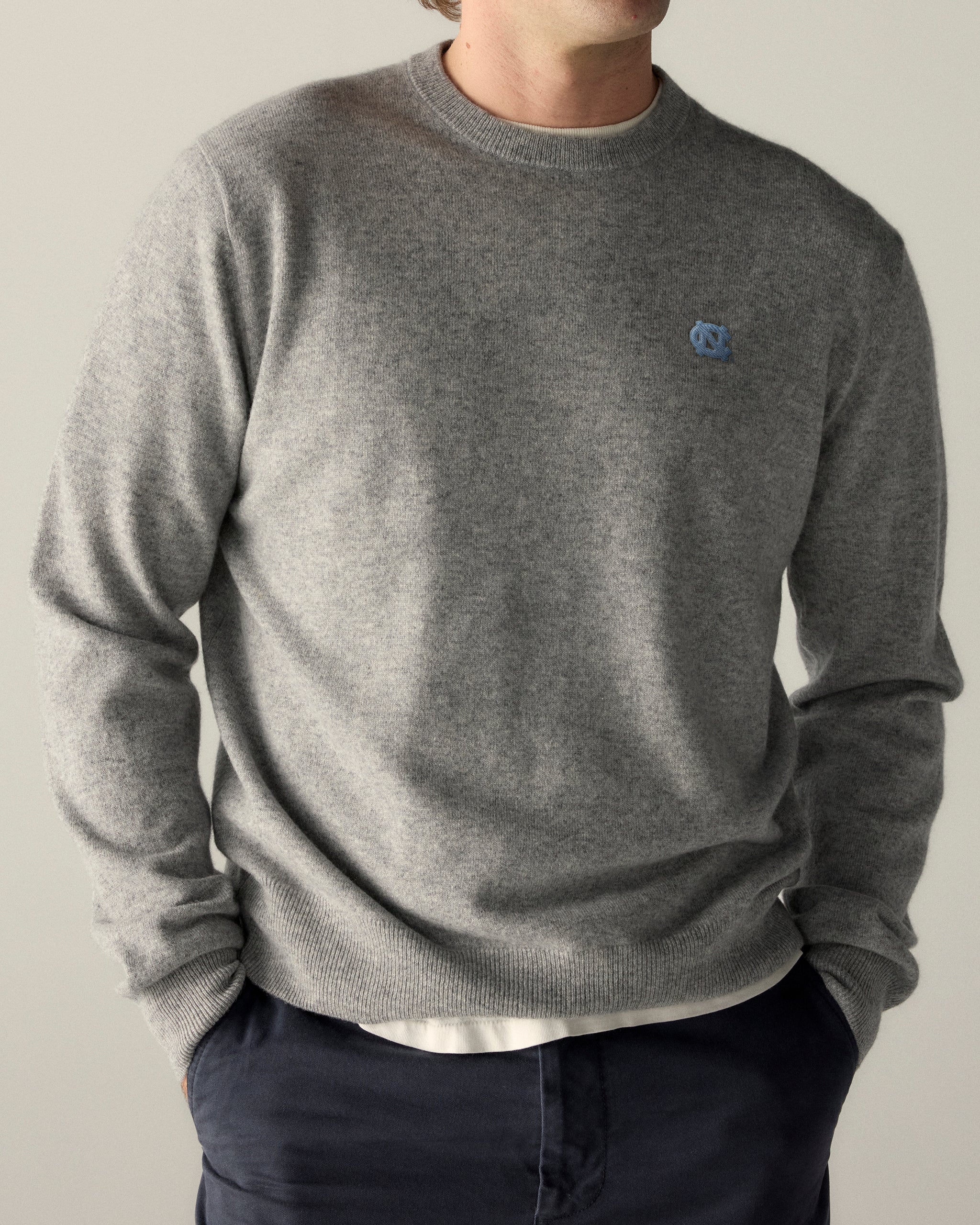 Gray crewneck sweater with UNC logo, premium collegiate apparel. Class Trip | Officially Licensed Collegiate Apparel