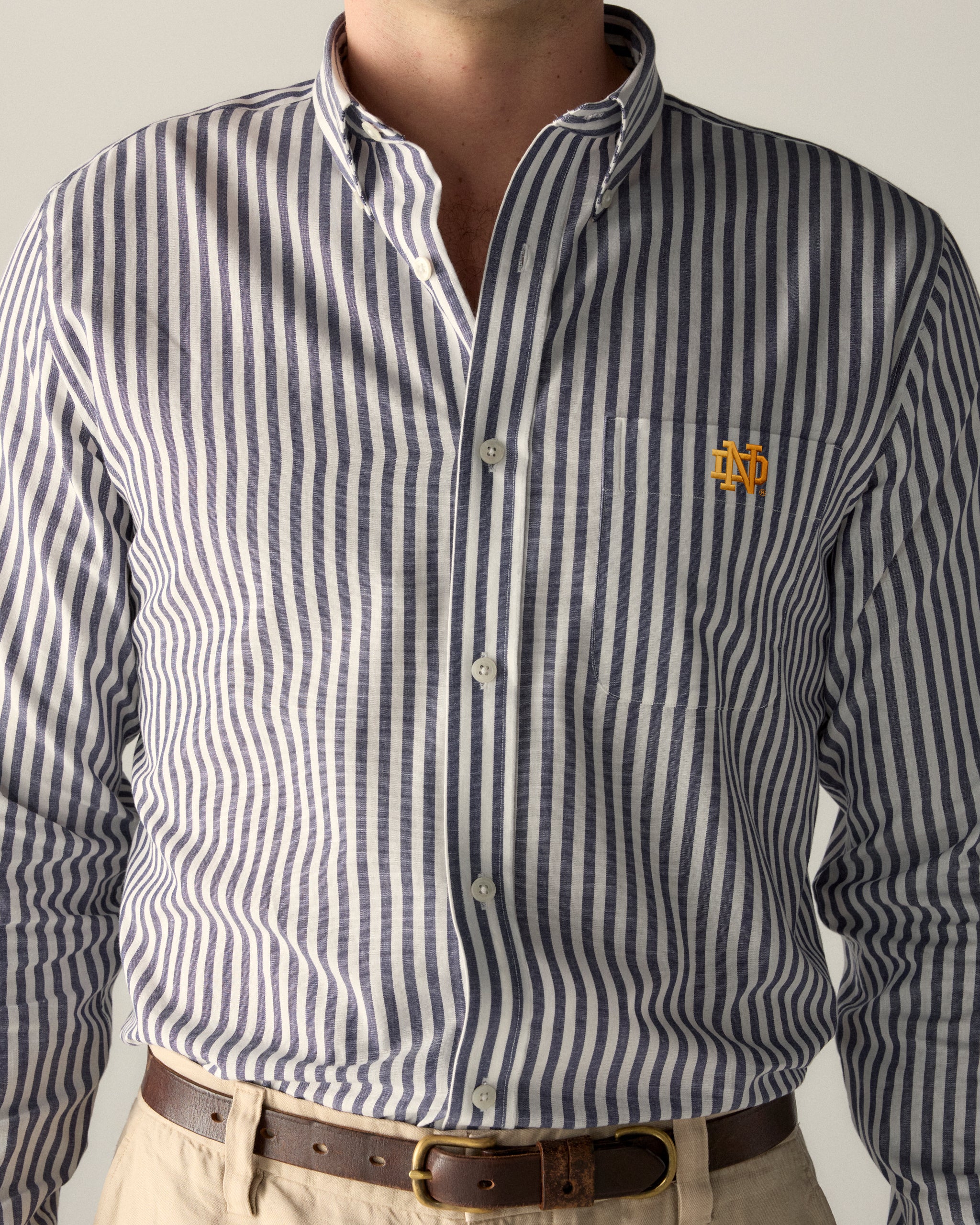Men's striped button-down shirt with collegiate logo embroidery on chest. Class Trip | Officially Licensed Collegiate Apparel