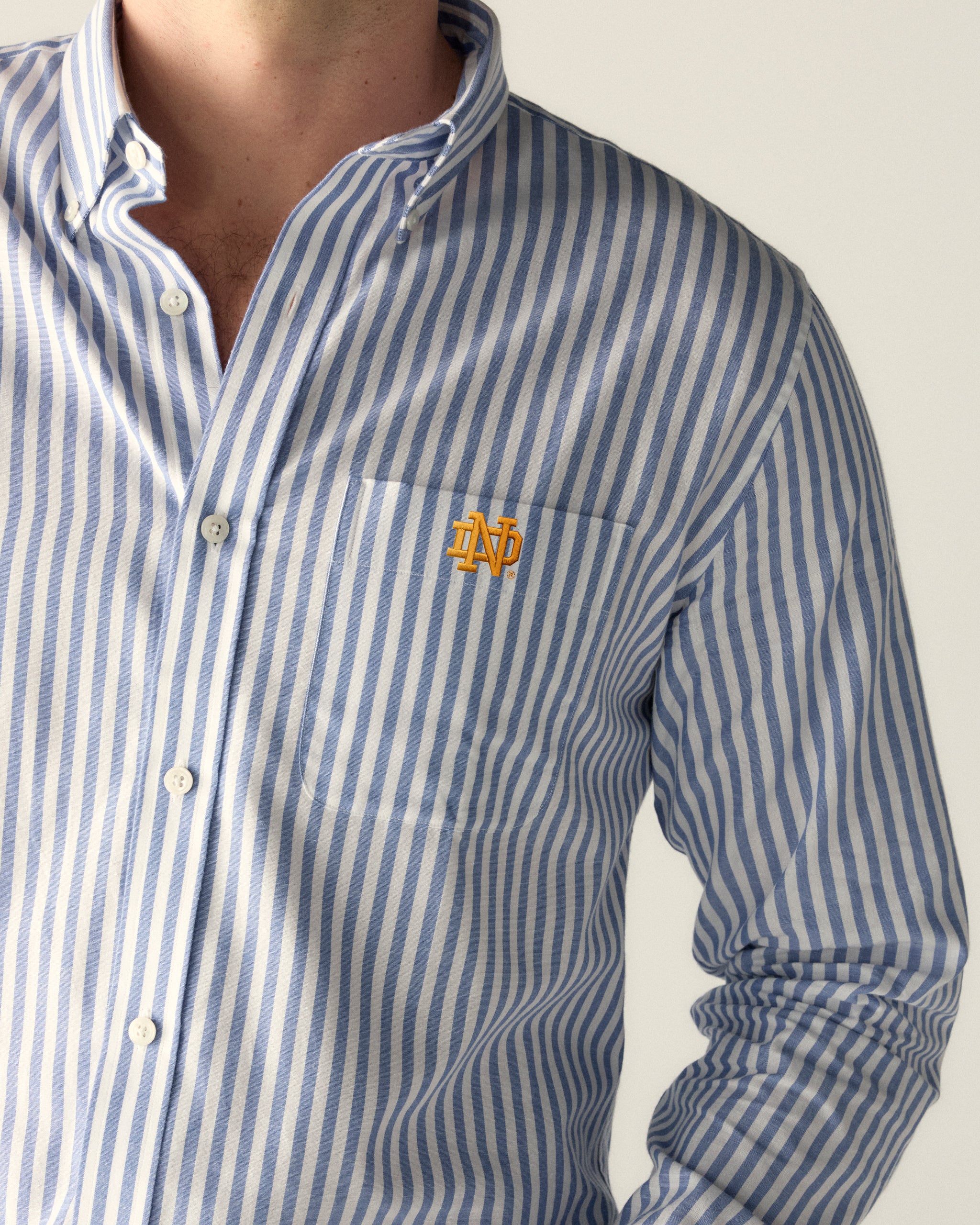 Blue and white striped button-down shirt with collegiate logo on pocket, Class Trip | Officially Licensed Collegiate Apparel