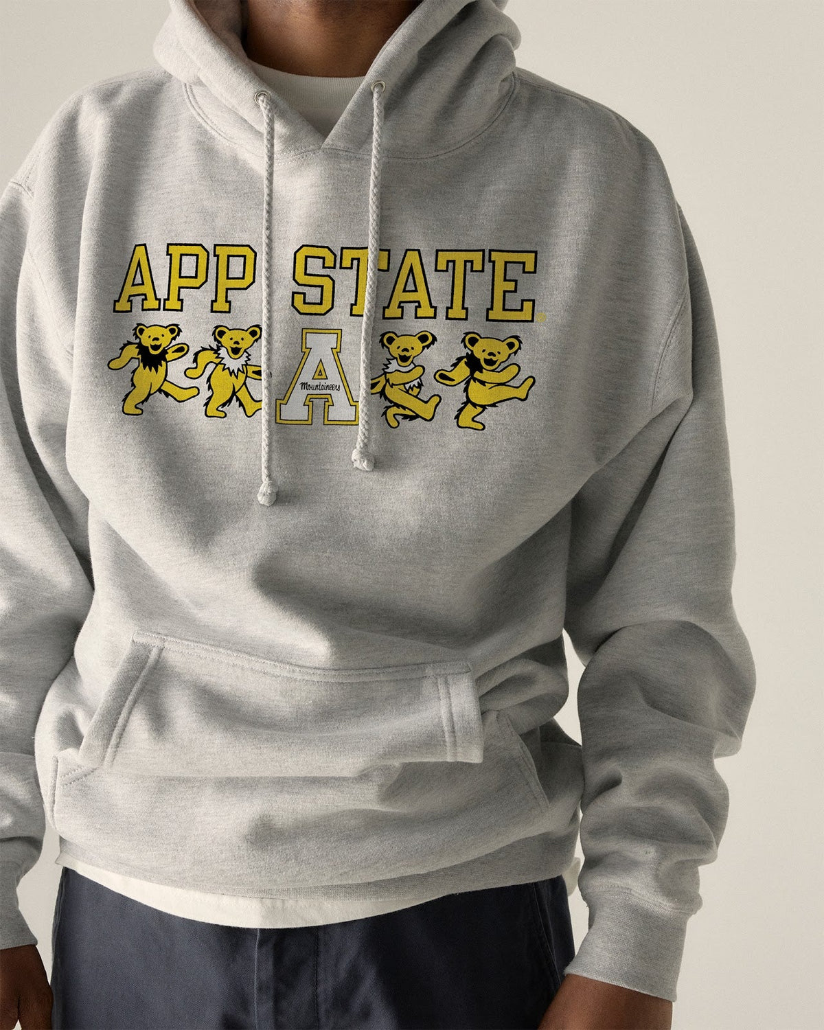 Model wearing the Heather Grey Appalachian State x Grateful Dead Mascot Bears Hoodie, front view. Class Trip | Higher Education