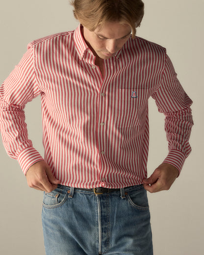 Man wearing red and white striped button-down shirt with Arizona 'A' logo, paired with jeans. Class Trip | Officially Licensed Collegiate Apparel