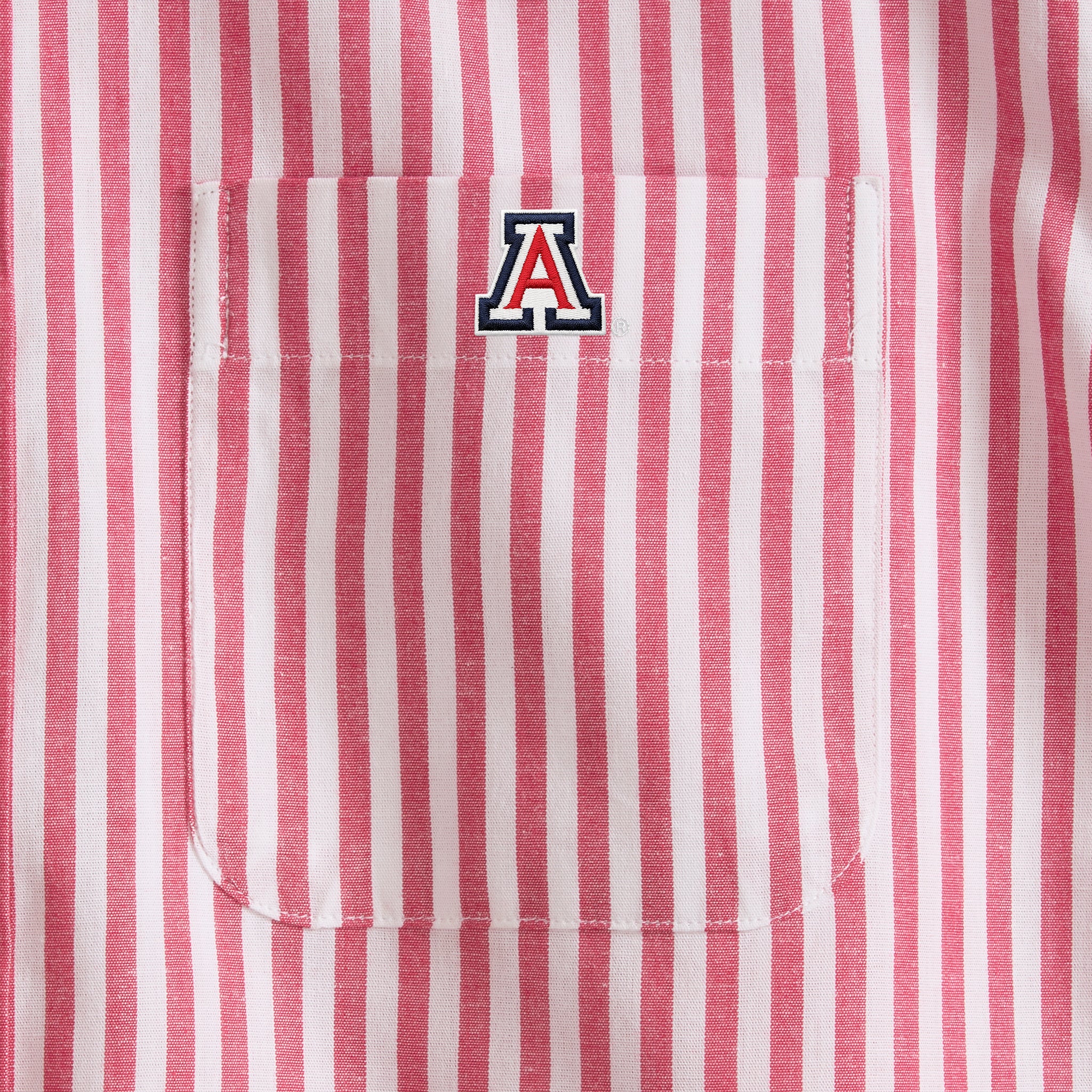 Red and white striped collegiate shirt with embroidered 'A' logo on chest pocket. Class Trip | Officially Licensed Collegiate Apparel