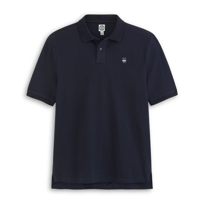 Navy pique polo shirt with embroidered collegiate logo, short sleeves, flat lay. Class Trip | Officially Licensed Collegiate Apparel
