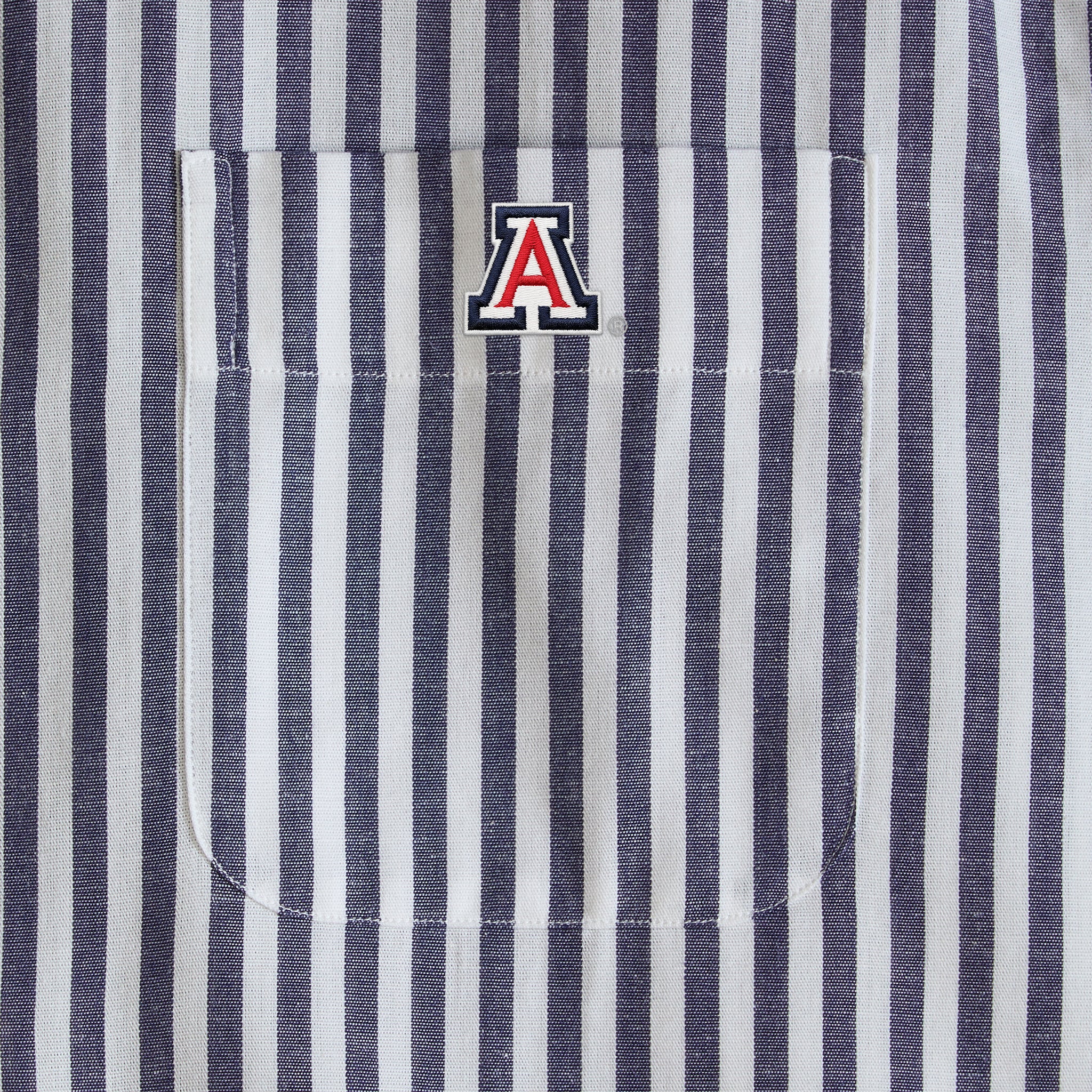 Navy and white striped shirt pocket with collegiate embroidered logo, Class Trip | Officially Licensed Collegiate Apparel