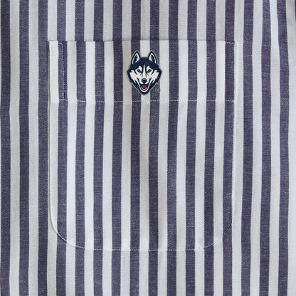 Navy and white striped shirt pocket with embroidered husky mascot patch detail. Class Trip | Officially Licensed Collegiate Apparel
