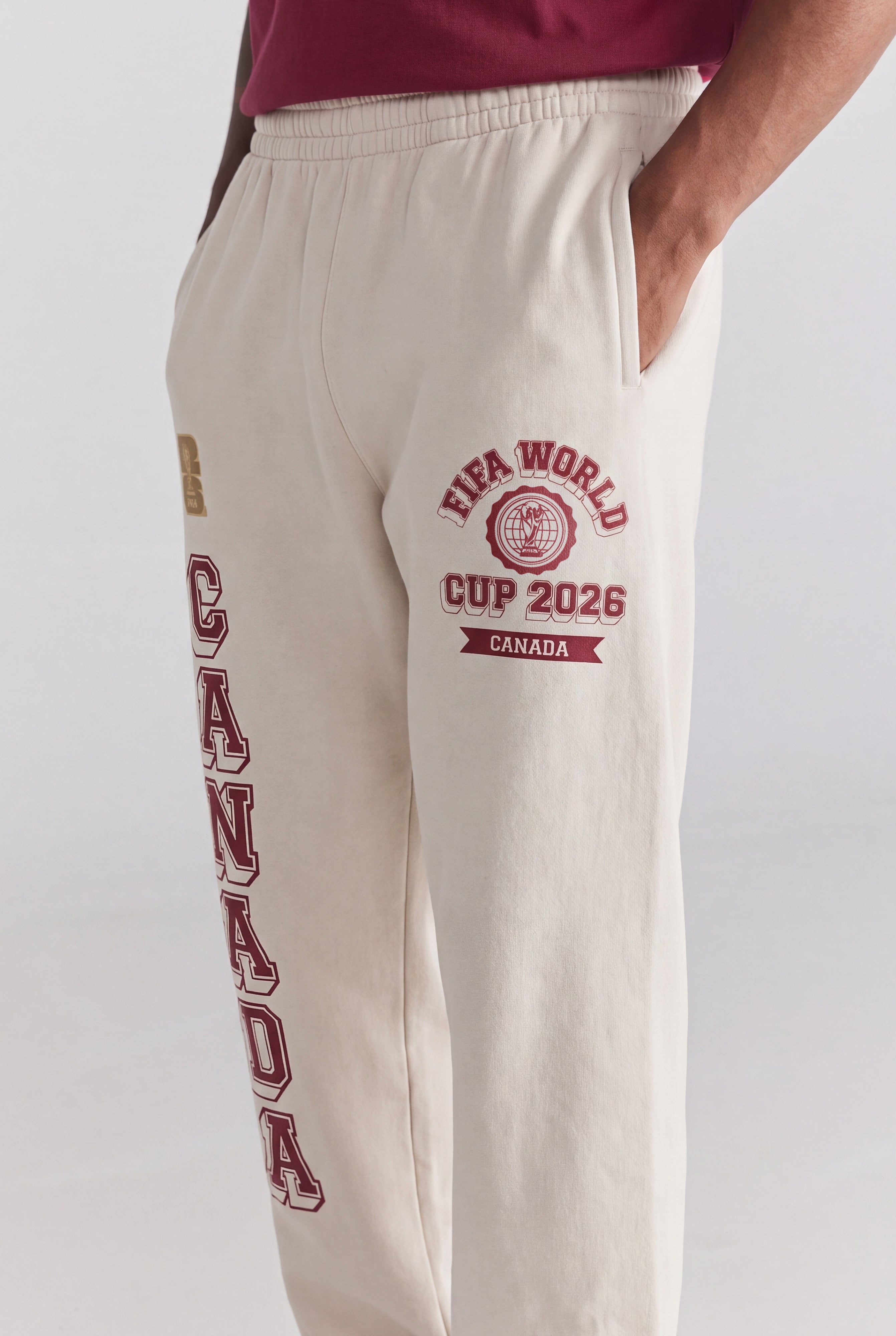 Cream sweatpants with FIFA World Cup 2026 Canada graphics, vintage collegiate style. Class Trip | Higher Education