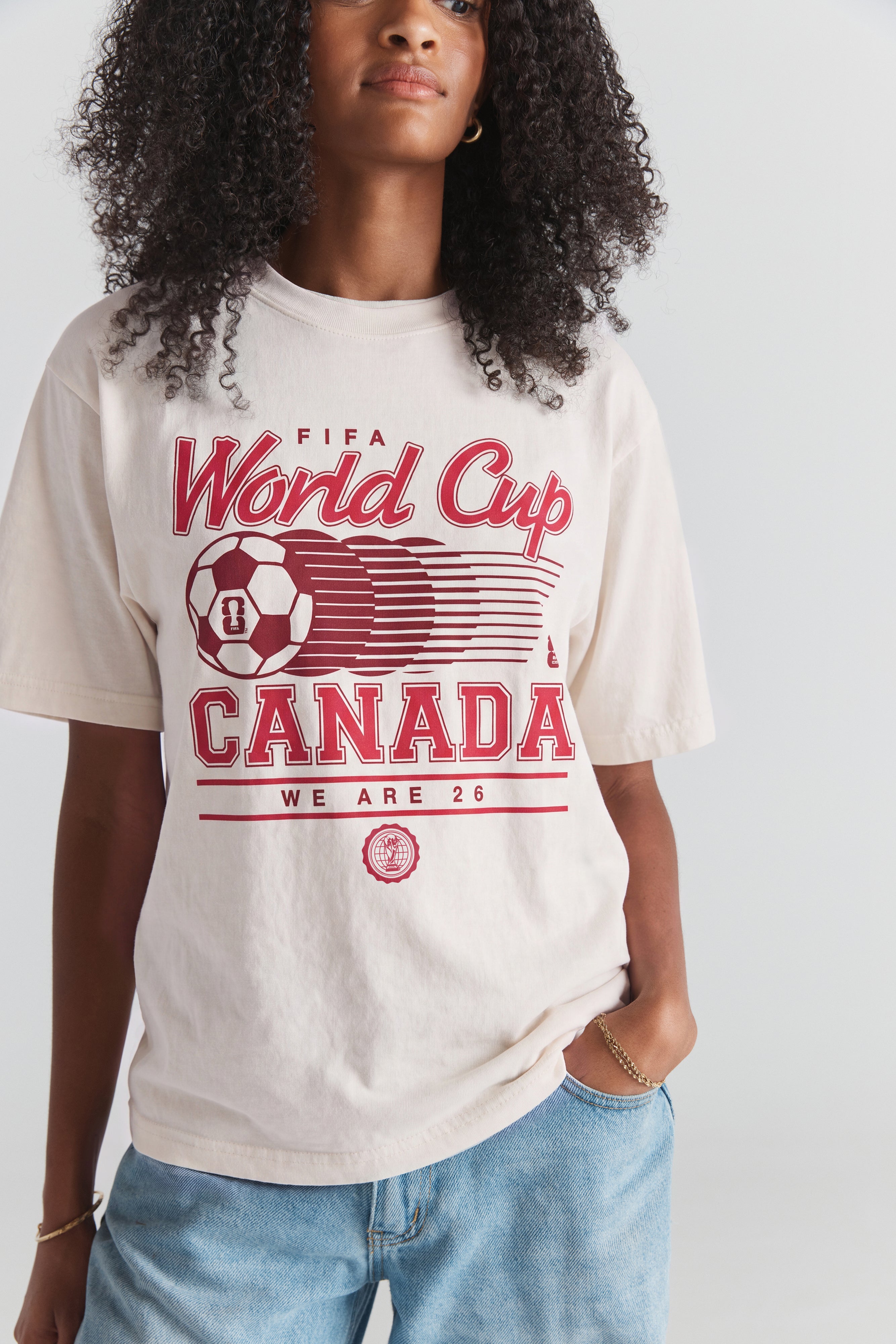 Cream FIFA World Cup Canada graphic tee with red soccer ball print, vintage style. Class Trip | Higher Education