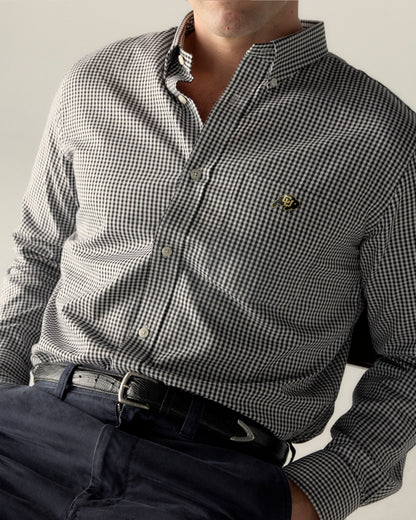 Men's black checkered Oxford shirt with collegiate logo and navy pants. Class Trip | Officially Licensed Collegiate Apparel