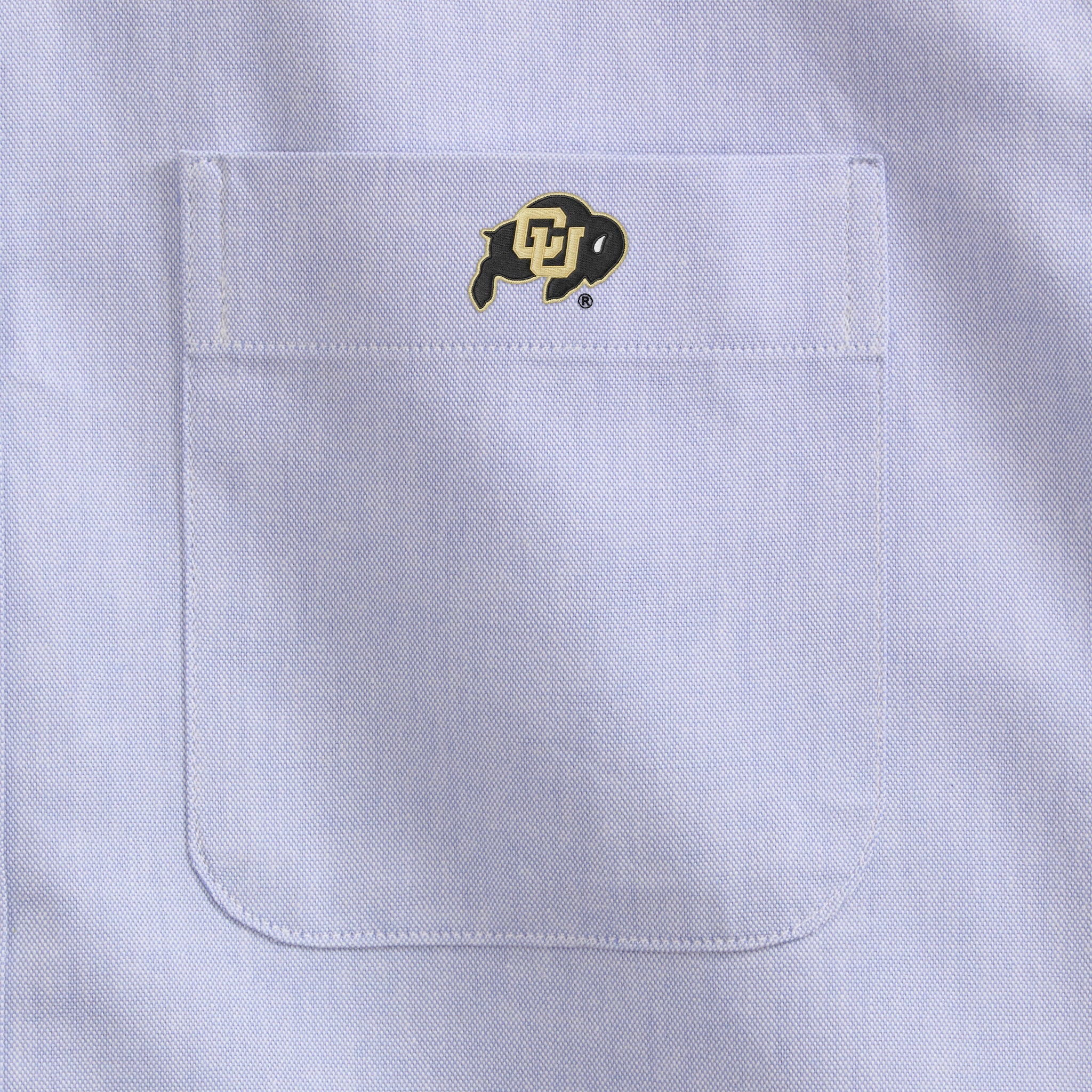 Oxford blue men's shirt pocket with embroidered collegiate buffalo logo. Class Trip | Officially Licensed Collegiate Apparel
