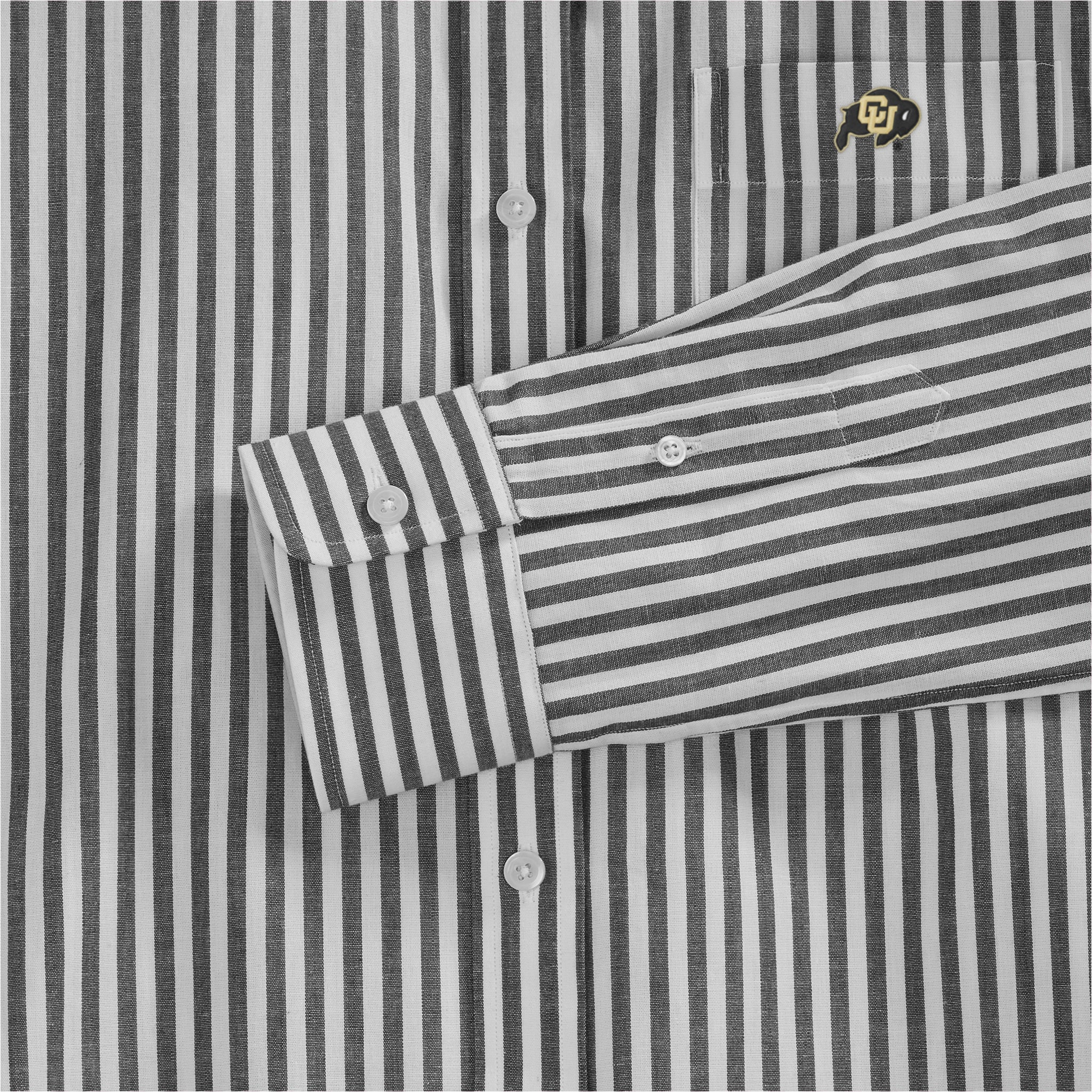 Close-up of black and white striped women's poplin shirt with embroidered university logo, button details. Class Trip | Officially Licensed Collegiate Apparel