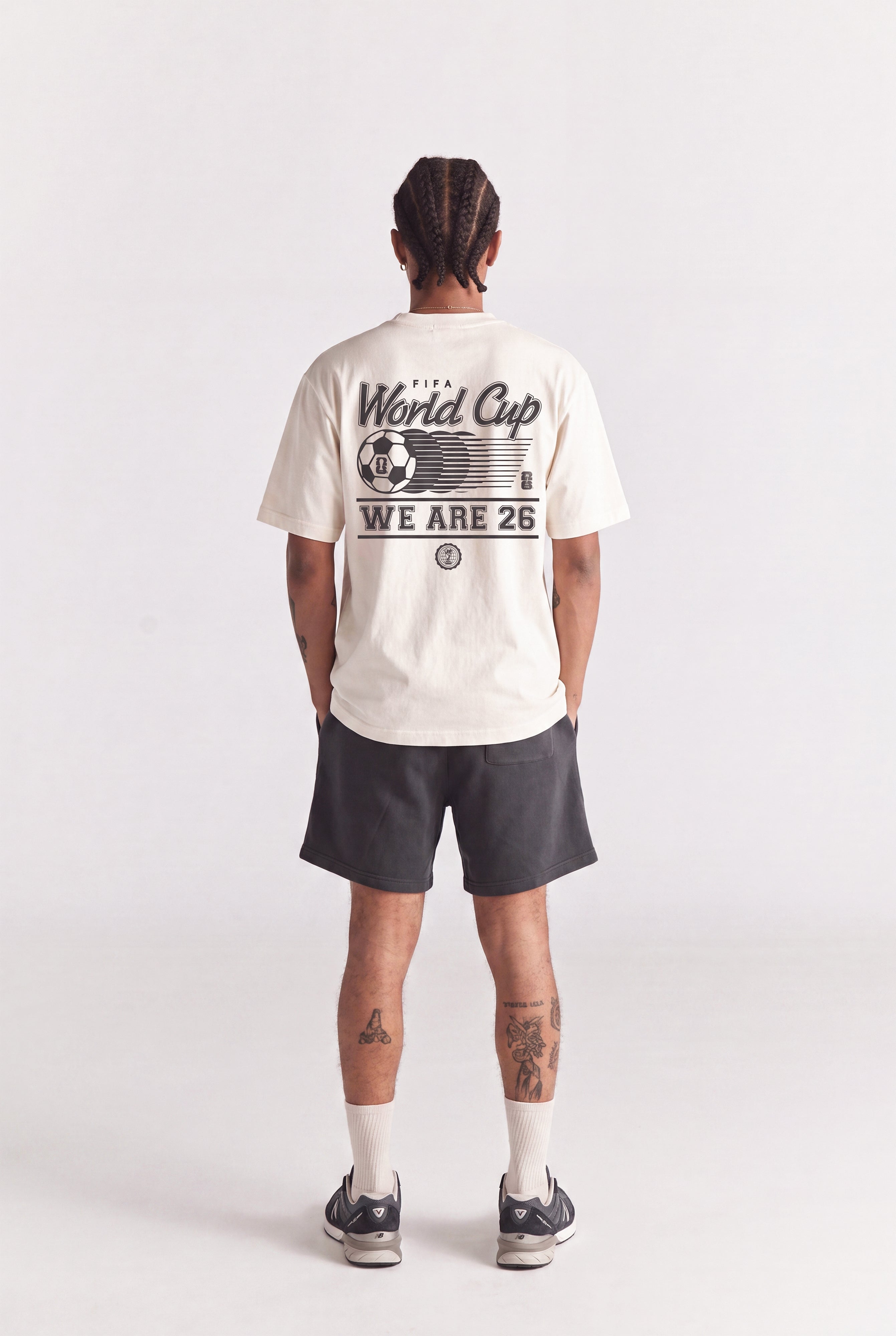 Cream FIFA World Cup graphic tee with 'WE ARE 26' print, worn with dark shorts. Class Trip | Higher Education