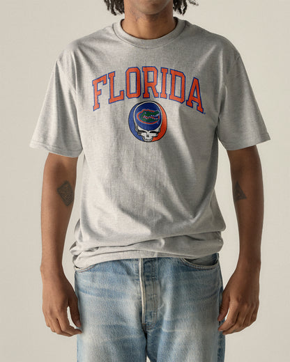 Man wearing a grey Florida x Grateful Dead Steal Your Face Arch Tee. Class Trip | Higher Education