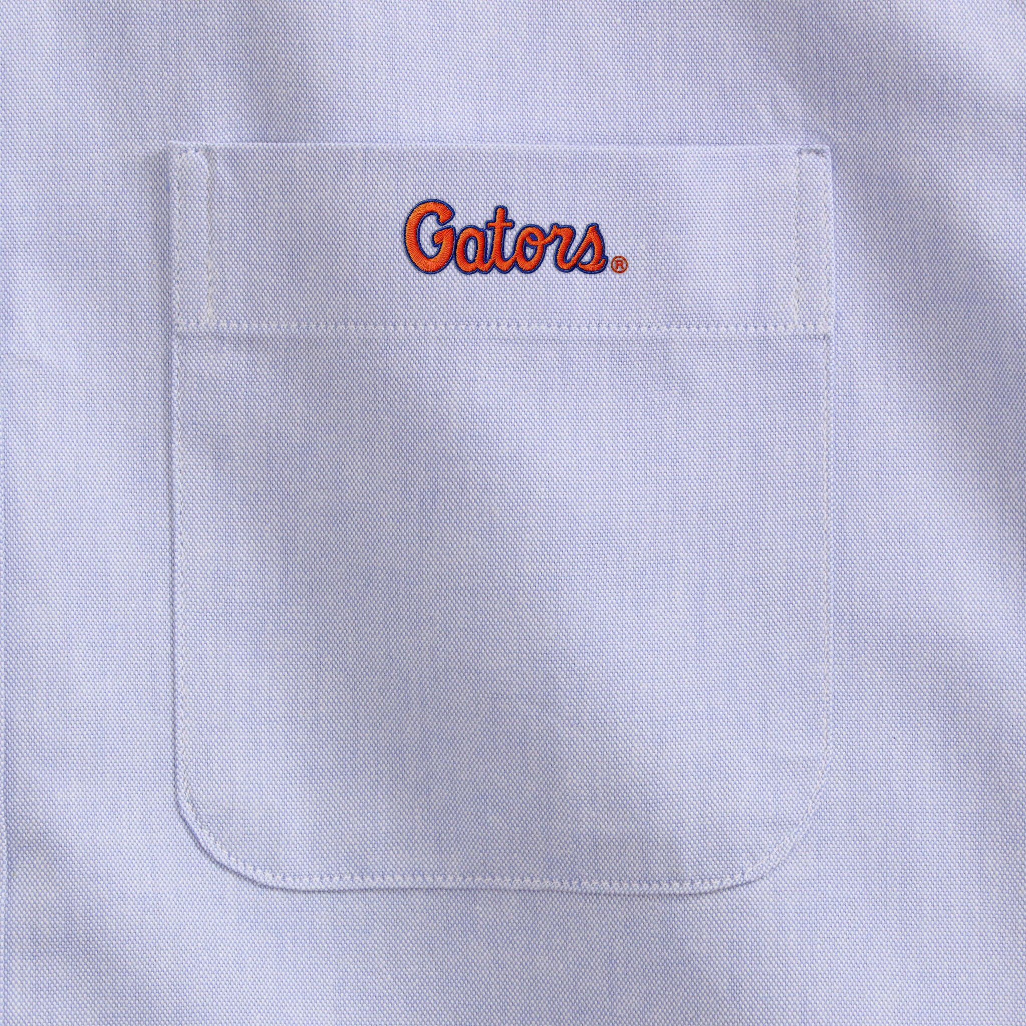 Light blue men's oxford shirt pocket with Gators logo embroidery, Class Trip | Officially Licensed Collegiate Apparel