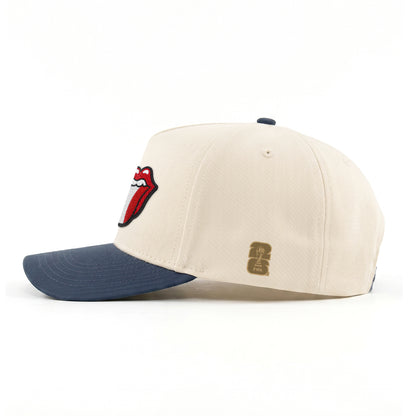 Cream and navy cap with Rolling Stones tongue logo, FIFA patch. Class Trip | Higher Education