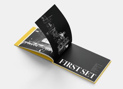 Open booklet with 'FIRST SET' text and black-and-white concert photos, yellow page edges. Class Trip | Officially Licensed Collegiate Apparel
