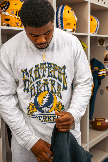 Man wearing a white Cal Berkeley x Grateful Dead long sleeve tee by Class Trip. Cal Berkeley x Grateful Dead Steal Your Face Long Sleeve Tee Class Trip | Higher Education