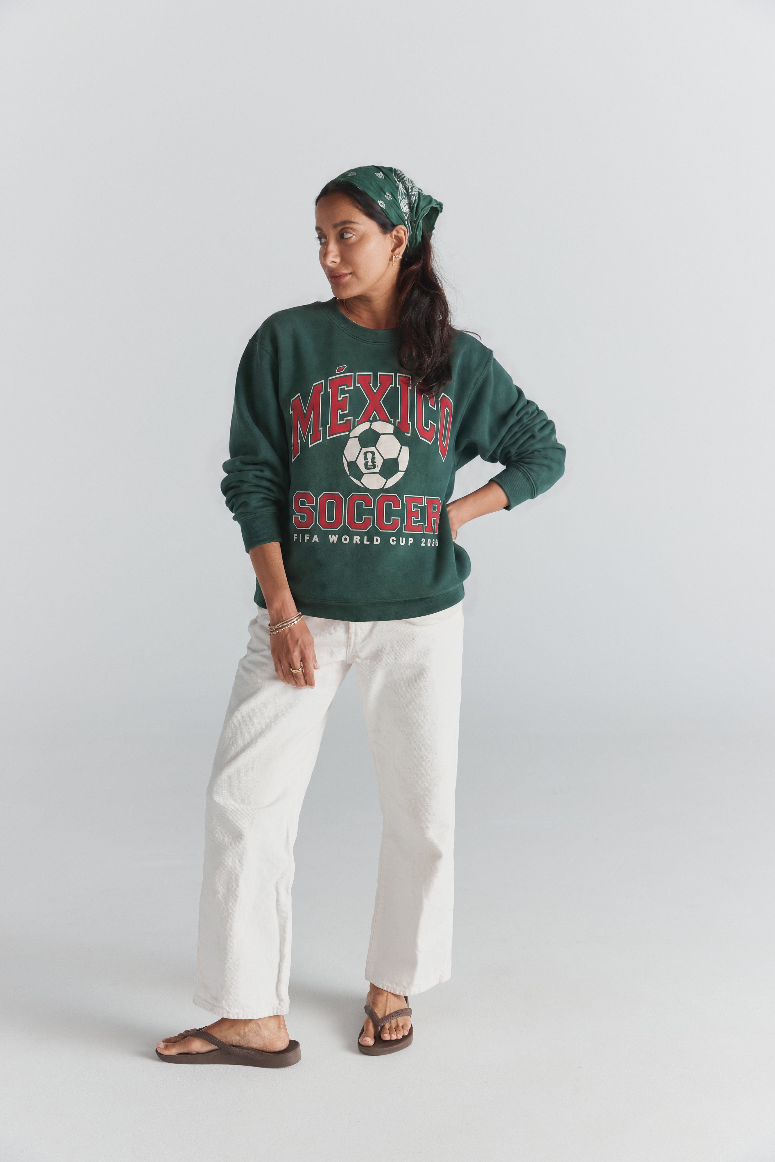 Green Mexico Soccer sweatshirt with FIFA World Cup 2026 graphic, worn with white pants and bandana. Class Trip | Higher Education