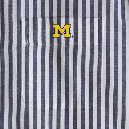 Navy and white striped men's shirt pocket with yellow collegiate M logo. Class Trip | Officially Licensed Collegiate Apparel