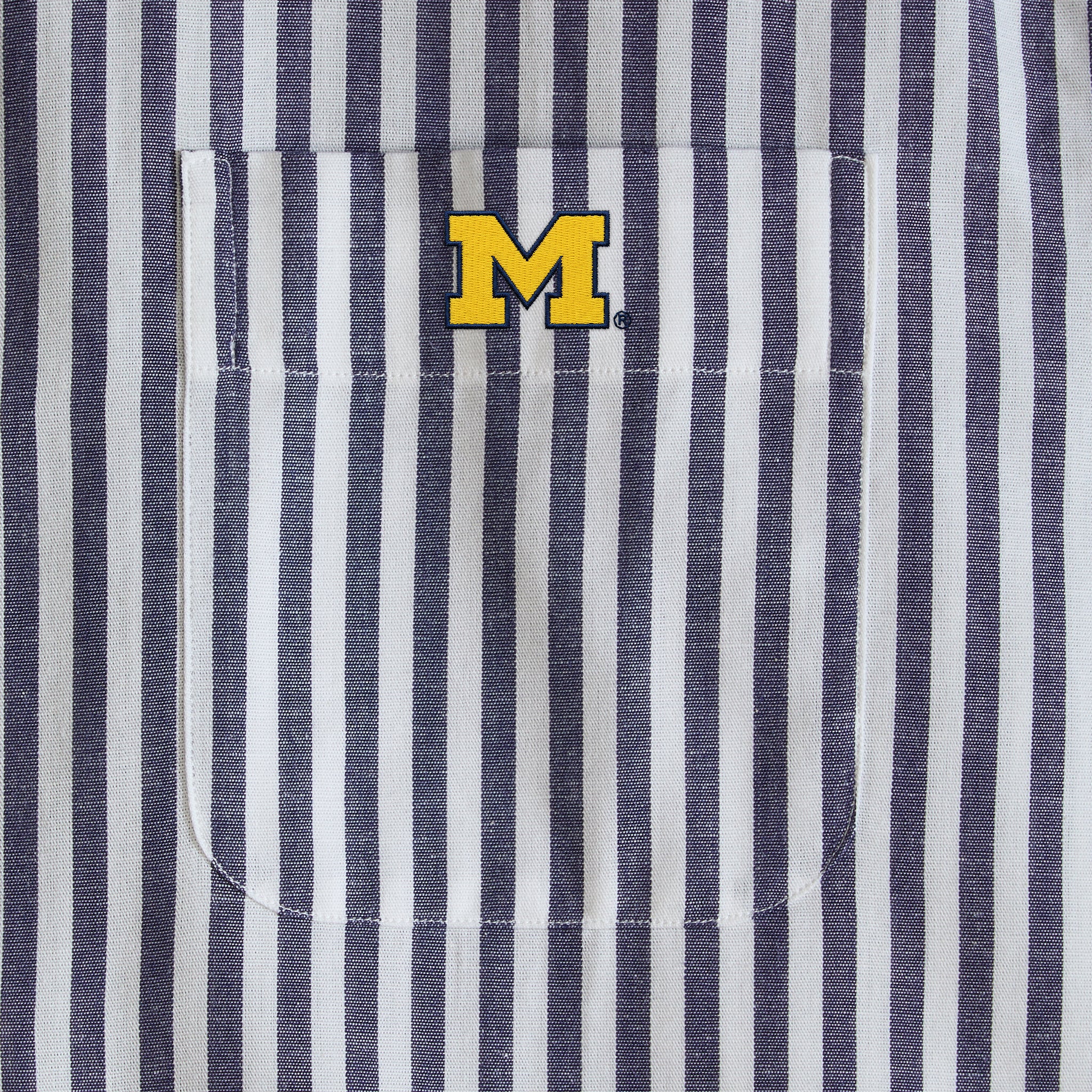 Navy and white striped poplin shirt pocket with yellow collegiate M logo, Class Trip | Officially Licensed Collegiate Apparel