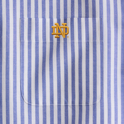 Blue and white striped poplin shirt pocket with yellow embroidered collegiate logo. Class Trip | Officially Licensed Collegiate Apparel