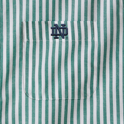 Green and white striped men's shirt pocket with navy college initials embroidery. Class Trip | Officially Licensed Collegiate Apparel