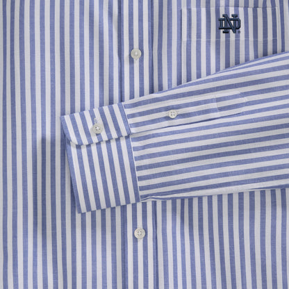 Close-up of blue and white striped women's poplin shirt with embroidered collegiate logo, button details. Class Trip | Officially Licensed Collegiate Apparel
