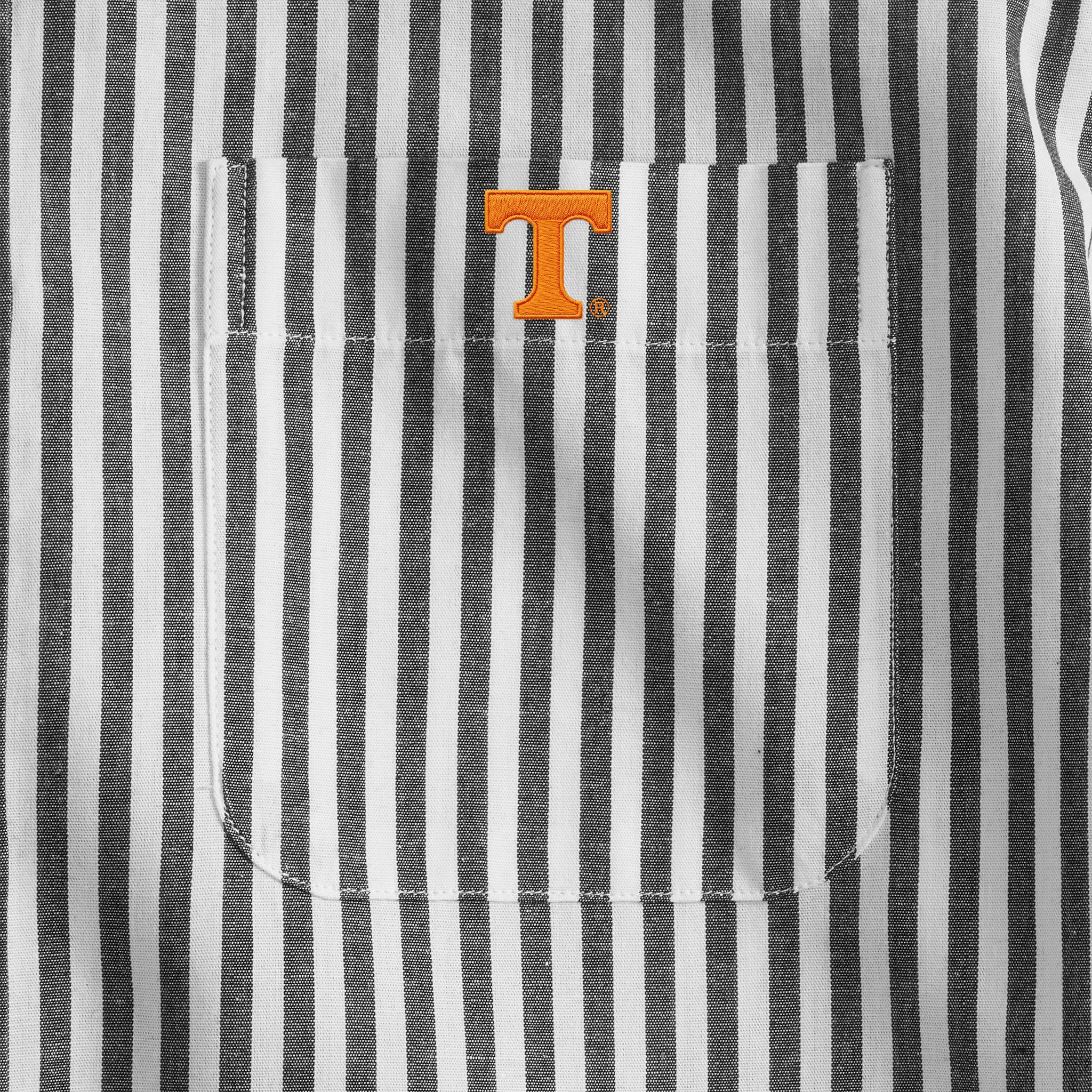 Close-up of black and white striped men's shirt pocket with orange collegiate logo, Class Trip | Officially Licensed Collegiate Apparel