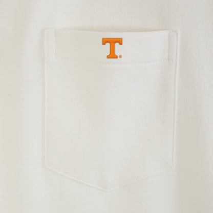 White polo shirt pocket with orange collegiate T logo embroidery. Class Trip | Officially Licensed Collegiate Apparel