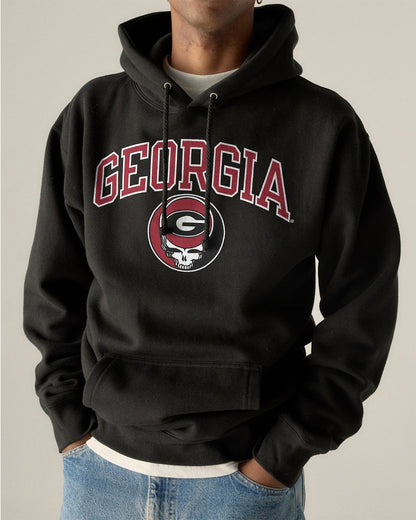 Model wearing the Black Georgia x Grateful Dead Steal Your Face Arch Hoodie, front view. Class Trip | Higher Education