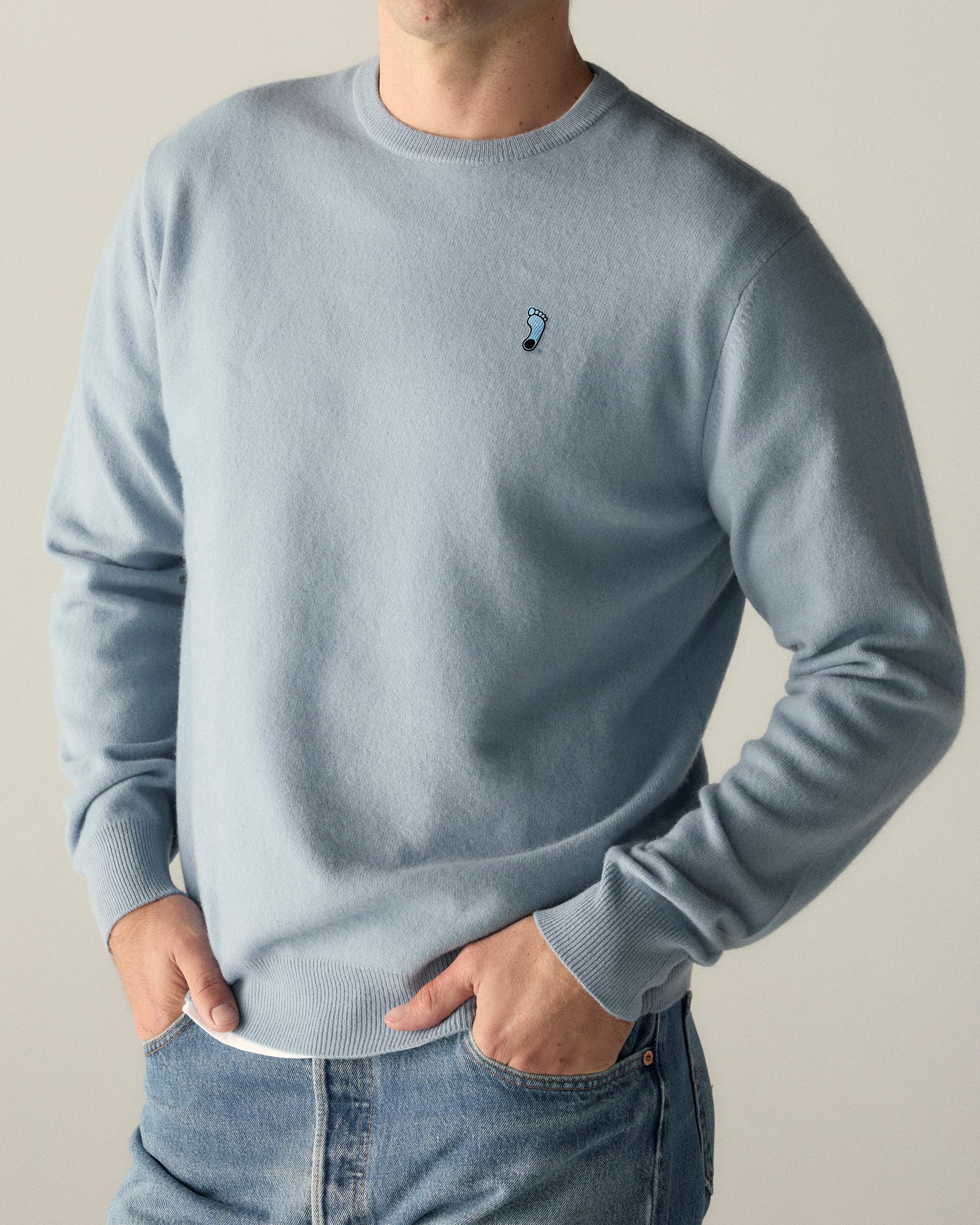 Men's baby blue merino crewneck sweater with small collegiate emblem, casual outfit. Class Trip | Officially Licensed Collegiate Apparel