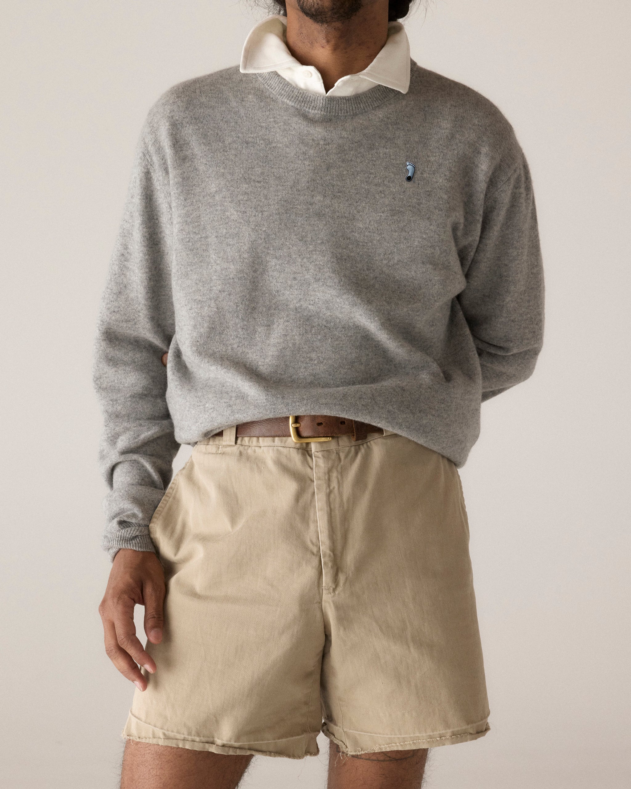 Grey crewneck sweater layered over white collared shirt, paired with khaki shorts and brown belt. Class Trip | Officially Licensed Collegiate Apparel