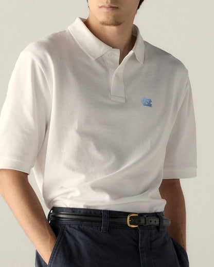 White UNC polo shirt with embroidered logo, collegiate apparel for campus style. Class Trip | Officially Licensed Collegiate Apparel