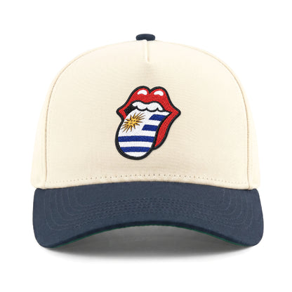 Cream and navy cap with Uruguay flag tongue logo, collegiate style. Class Trip | Higher Education