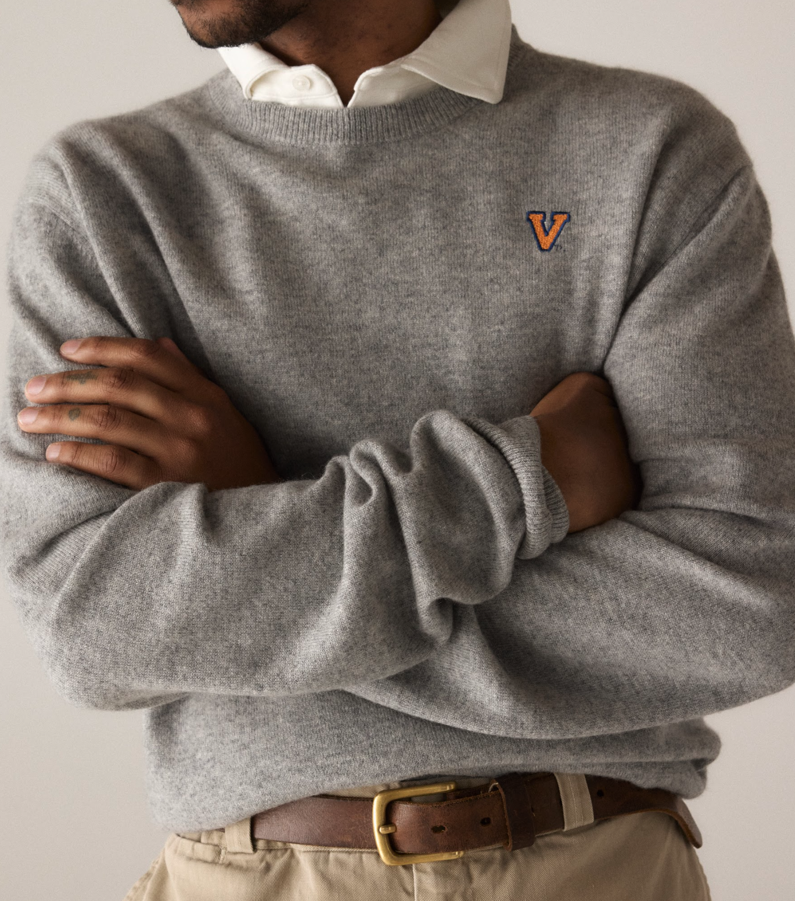 Man wearing a layered cashmere sweater, polo and khakis